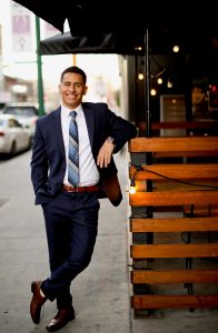 Dr. Andrew Ortega in a suit standing for a photo.